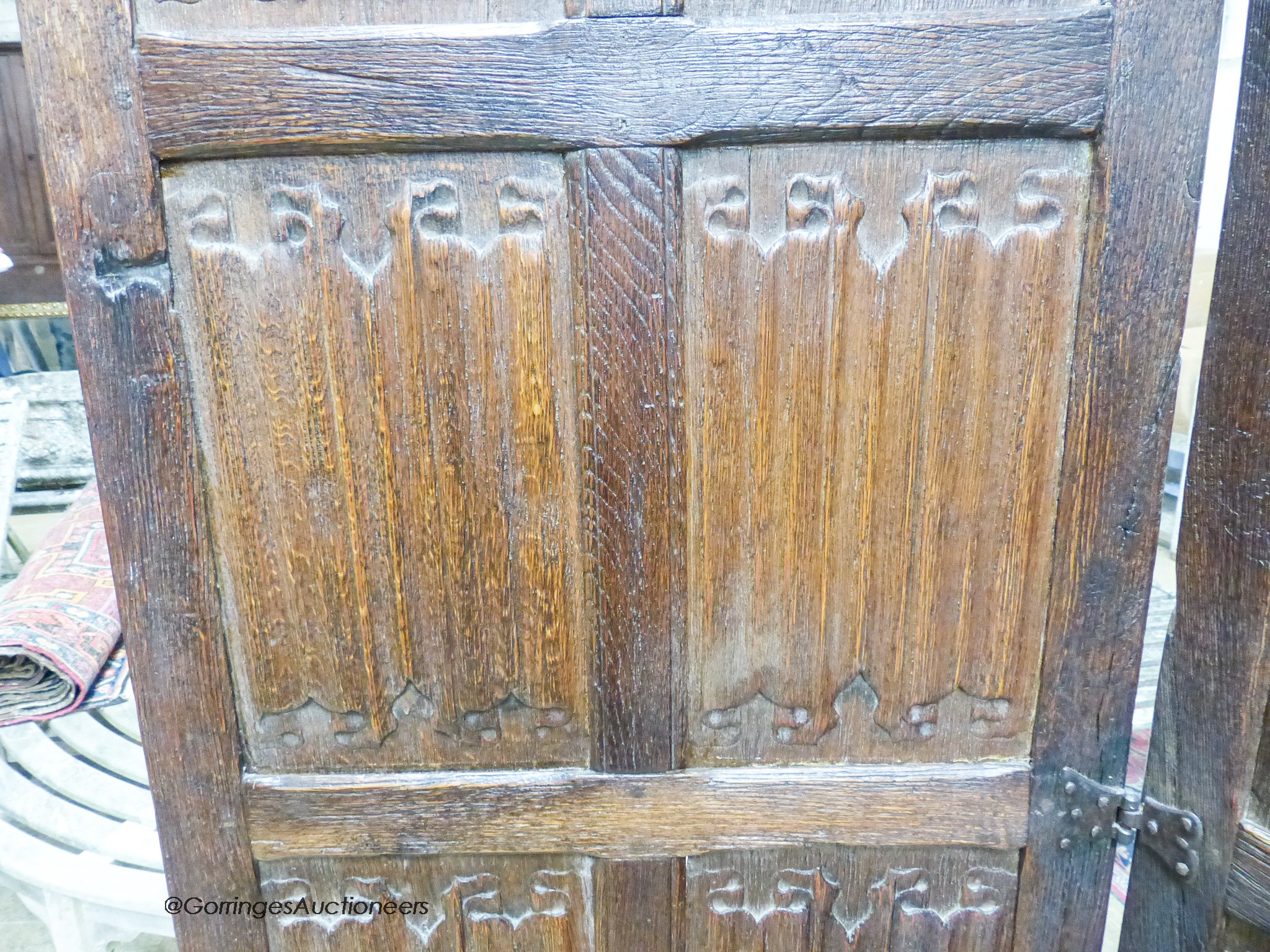 An oak three-fold screen incorporating twenty-four 16th / 17th century linenfold-carved panels, each panel width 59cm, height 182cm